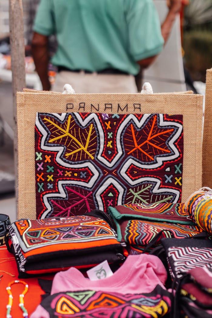 about-us Vibrant handcrafted textiles with intricate patterns displayed at a Panama market stall.